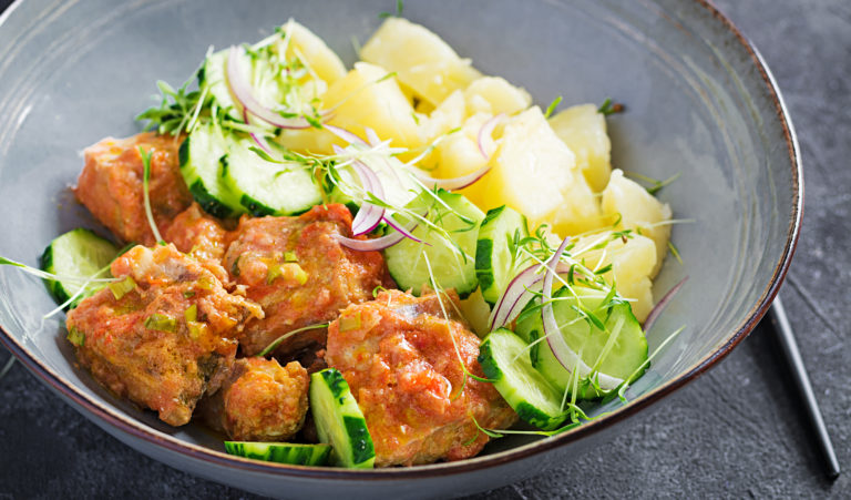 Steamed fish fillet with tomatoes sauce, boiled potatoes and fresh cucumber salad. Diet meal. Lenten food.